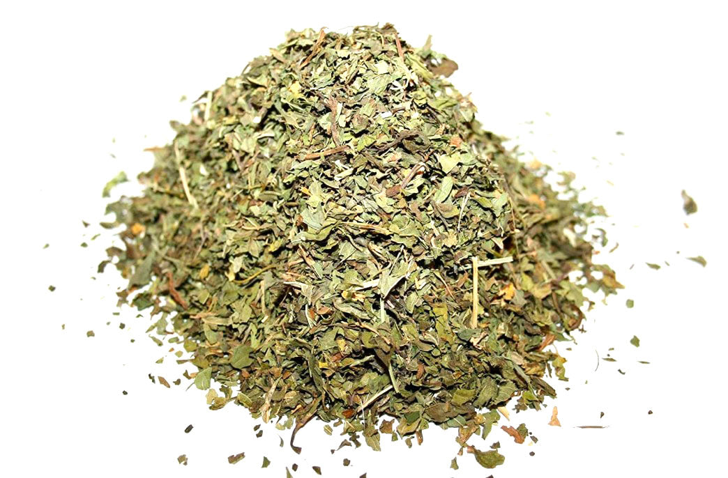 Pile of dried green spearmint herbs on a white background